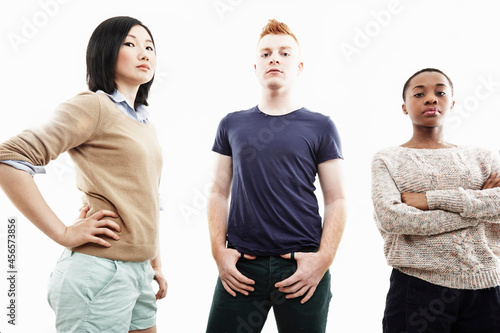 Canvas-taulu Studio portrait of three young individual adults