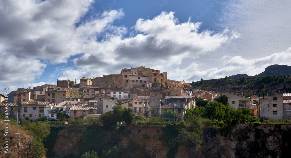 view of the profile of a village from its houses on the mountain with a sky full of clouds