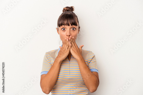 Young mixed race woman isolated on white background  shocked covering mouth with hands. © Asier