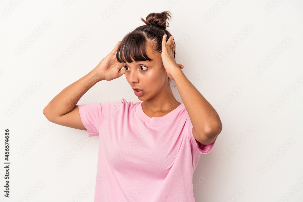 Young mixed race woman isolated on white background screaming, very excited, passionate, satisfied with something. Young mixed race woman isolated on white background screaming, very excited, passionate, satisfied with something.
