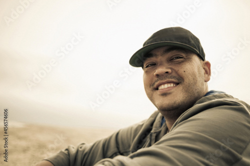 Portrait of smiling mid adult man on beach, Truro, Massachusetts, Cape Cod, USA