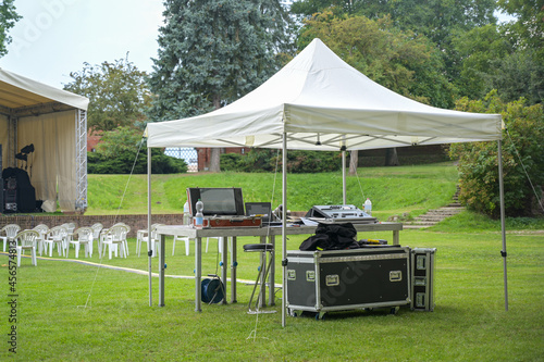 Tent for the sound engineers and their equipment at an open-air event on the lawn in the park
