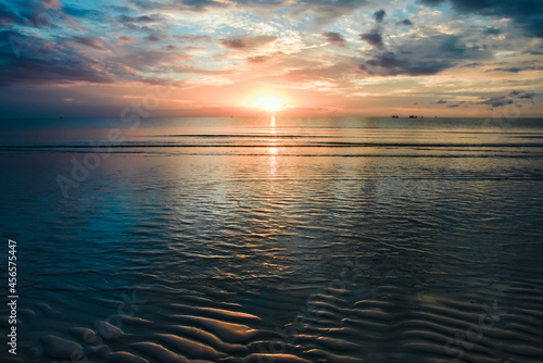 The sea in the morning when the sun had just risen and the golden light reflected the sea looked beautiful.