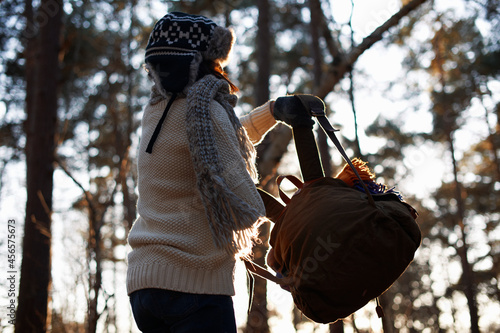 фотографія Mature female backpacker lifting up backpack in forest