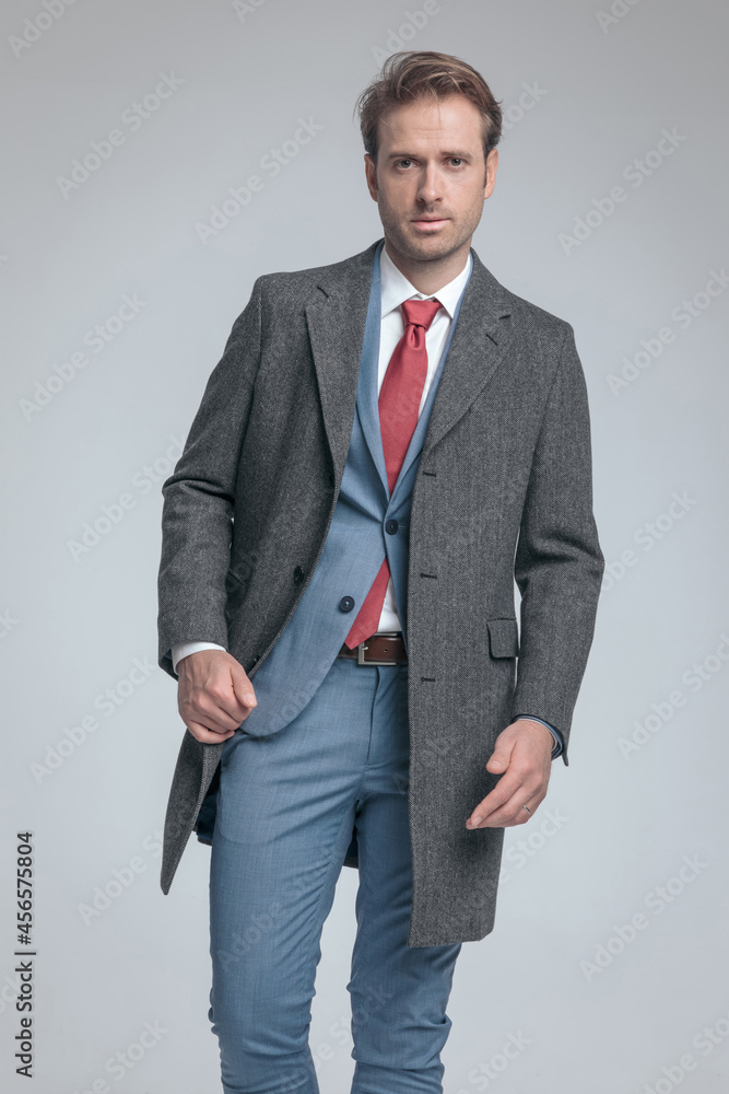 Fototapeta premium businessman holding his coat while posing with attitude