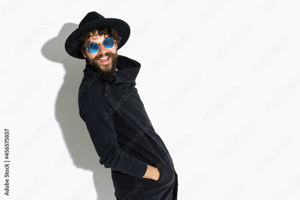 handsome casual guy posing with his hands in pockets handsome casual guy posing with his hands in pockets
