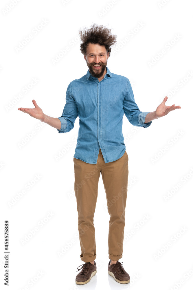 attractive casual man greeting with open arms and smiling attractive casual man greeting with open arms and smiling