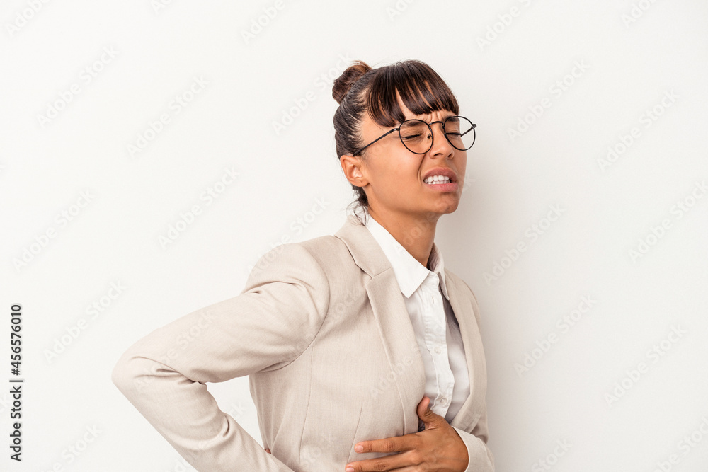Young mixed race woman isolated on white background  suffering a back pain.