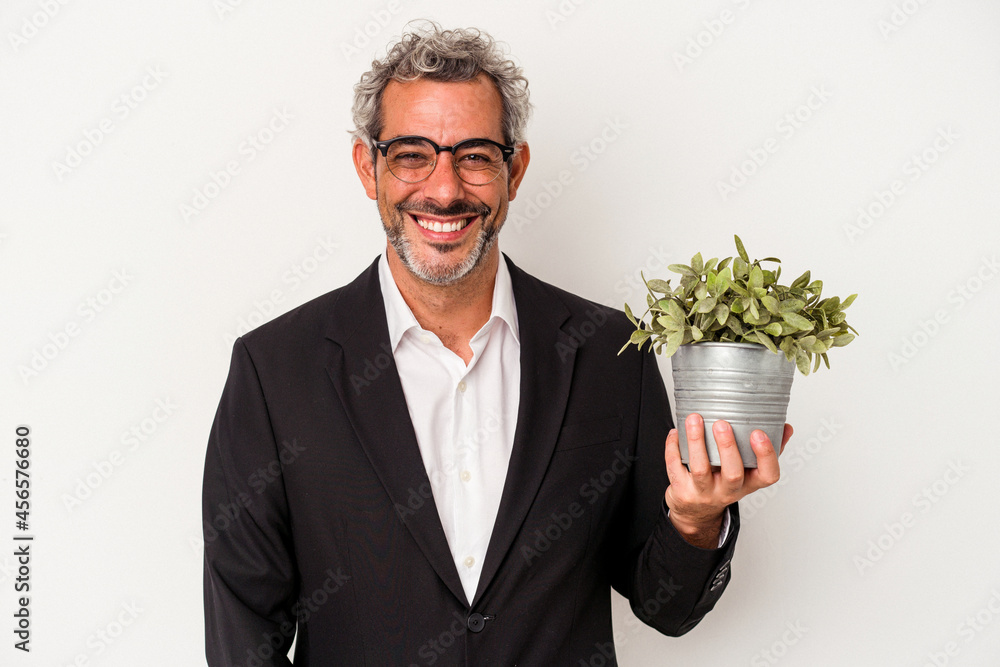 Middle age business man holding a plant isolated on white background happy, smiling and cheerful. Middle age business man holding a plant isolated on white background happy, smiling and cheerful.