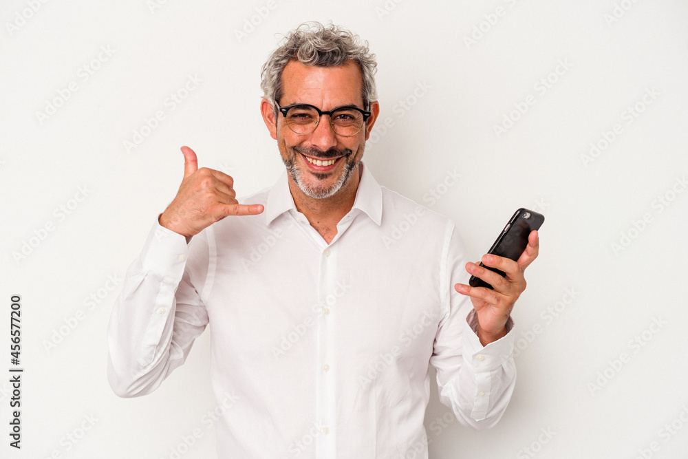 Middle age caucasian business man holding a mobile phone isolated on white background showing a mobile phone call gesture with fingers. Middle age caucasian business man holding a mobile phone isolated on white background showing a mobile phone call gesture with fingers.