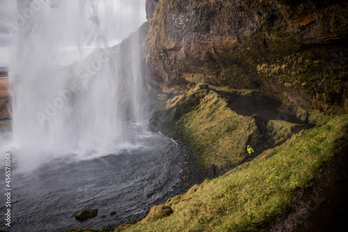 Male tourist at Seljalandsfoss waterfall  Iceland