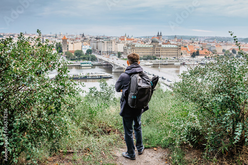 Canvas Print Young male backpacker enjoying view of Prague city skyline and Vltava river from Letna Park,Czech Republic