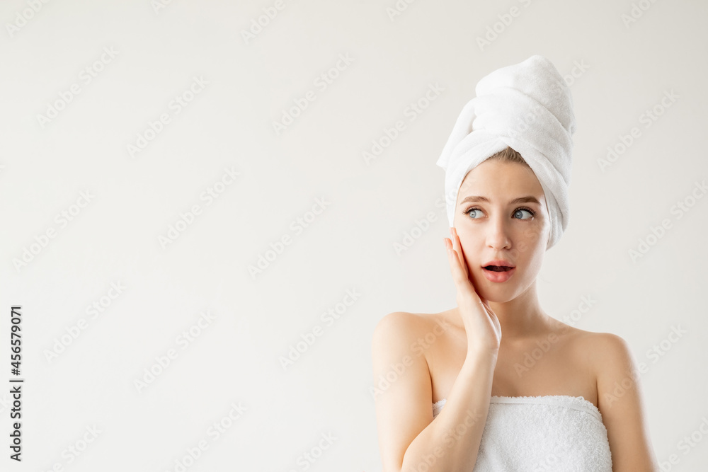 Natural beauty. Shocked woman. Spa procedure. Skin care. Pretty lady covering in towel looking shocked isolated white copy space. Natural beauty. Shocked woman. Spa procedure. Skin care. Pretty lady covering in towel looking shocked isolated white copy space.