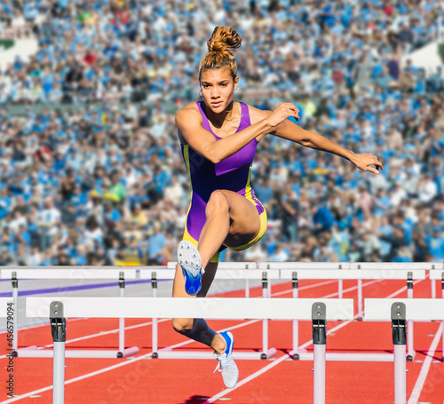 Canvas Print Runner jumping over hurdle on track