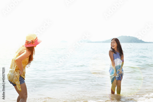 Girl and mother paddling in sea, Zhuhai, Guangdong, China