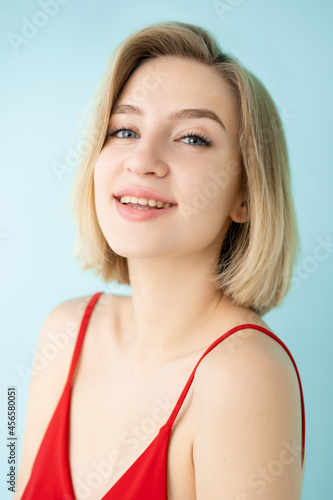 Natural skin care. Happy woman. Healthy treatment. Nourishing cosmetic. Beautiful smiling lady looking shiny isolated blue.