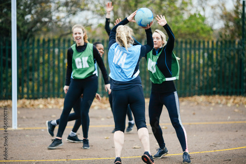 Fototapeta Naklejka Na Ścianę i Meble -  Female netball teams playing match on netball court