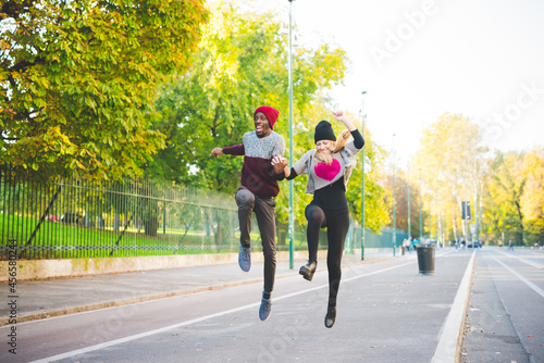 Couple skipping on street