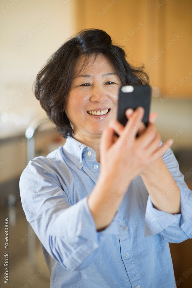 Mature woman taking selfie indoors Mature woman taking selfie indoors