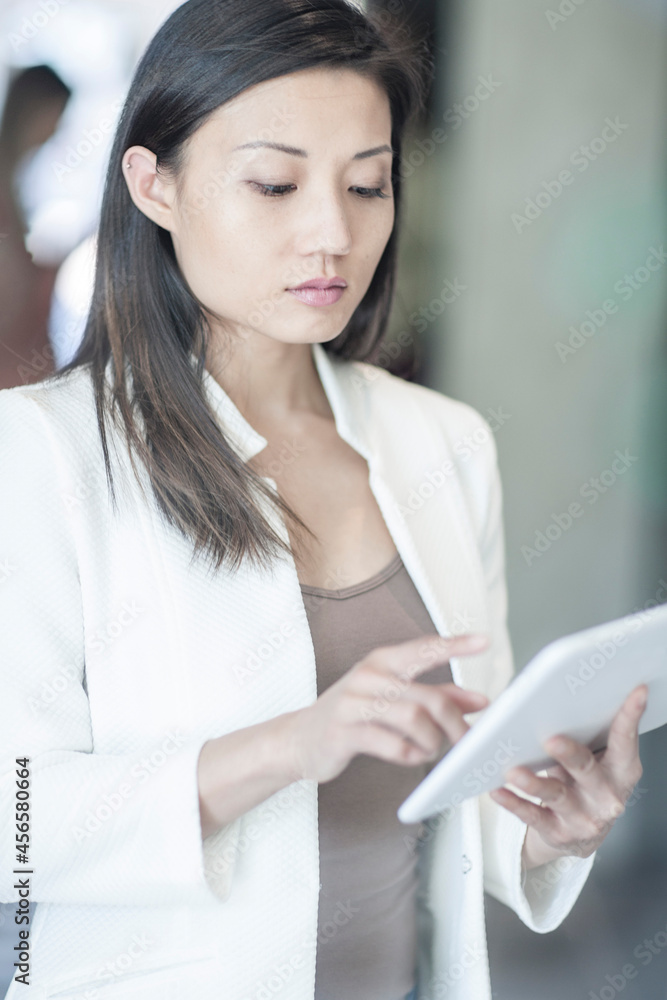 Mid adult businesswoman using digital tablet Mid adult businesswoman using digital tablet