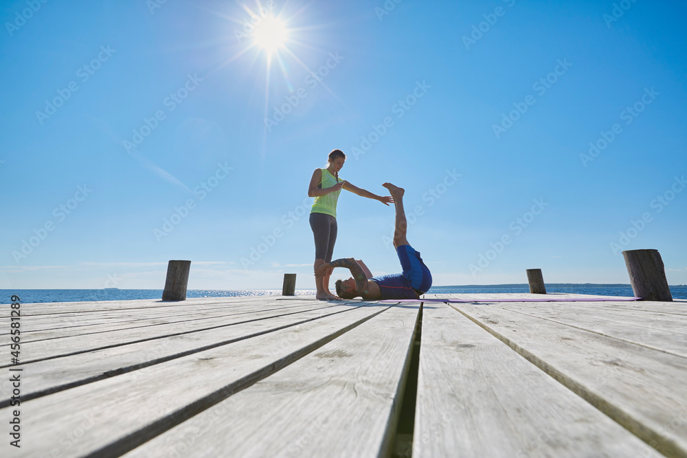 Mid distance view of women on pier exercising