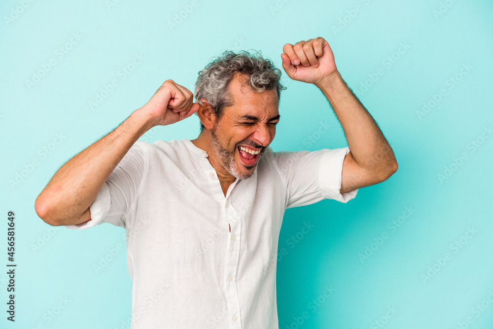 Middle age caucasian man isolated on blue background dancing and having fun. Middle age caucasian man isolated on blue background dancing and having fun.