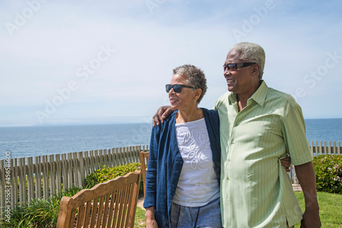 Senior couple walking outside, looking at view