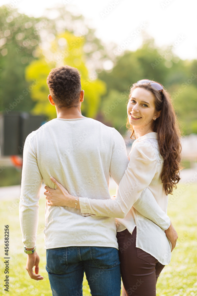 Rear view of couple with arms around each Rear view of couple with arms around each