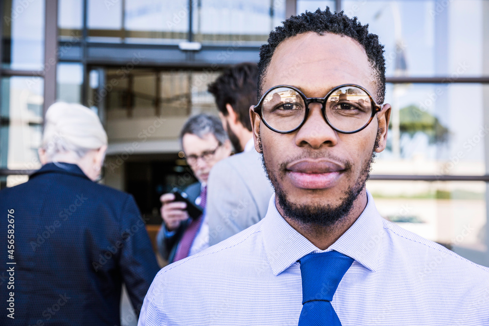 Fototapeta premium Portrait of businessman outside office building