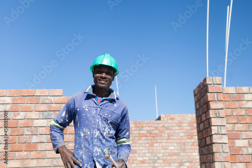 Portrait of builder wearing hard hat looking at camera smiling photo