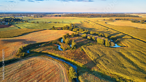 Obraz na płótnie September agriculture fields aerial panorama. Sunny autumn landscape. Meadows, river, village w salonie