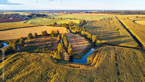 Obraz na płótnie Sunny autumn landscape. Meadows, river, village, dirt road Belarus. Corn harvest. w salonie