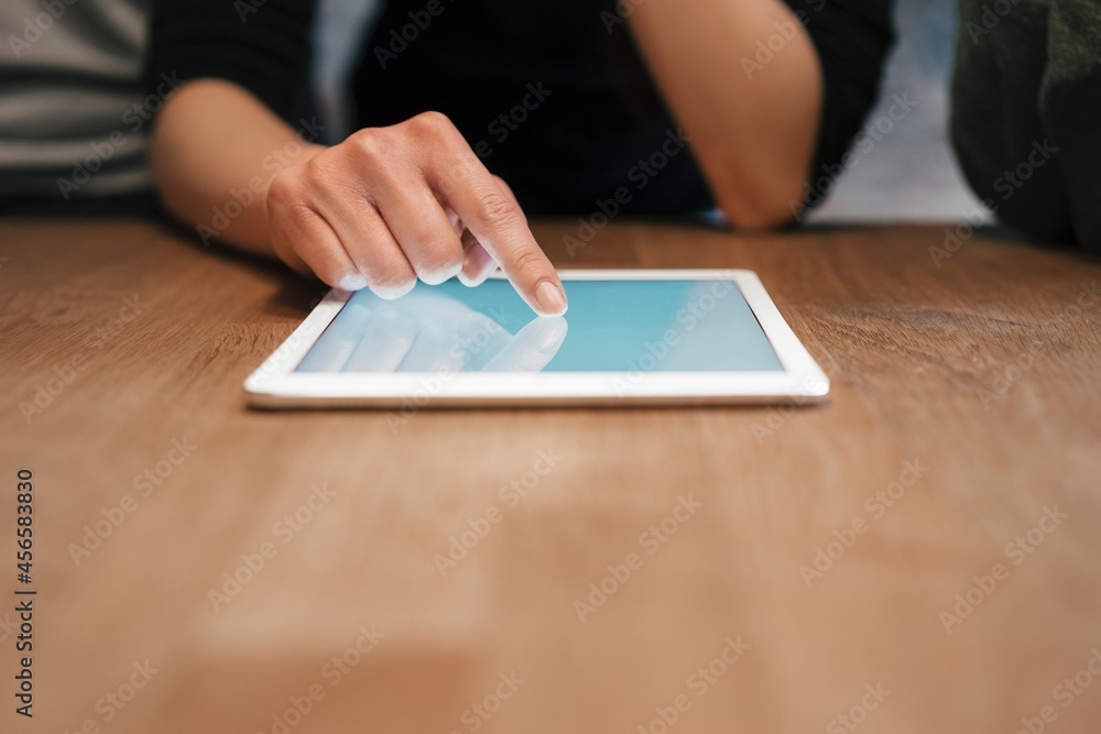 Cropped view of woman using digital tablet Cropped view of woman using digital tablet