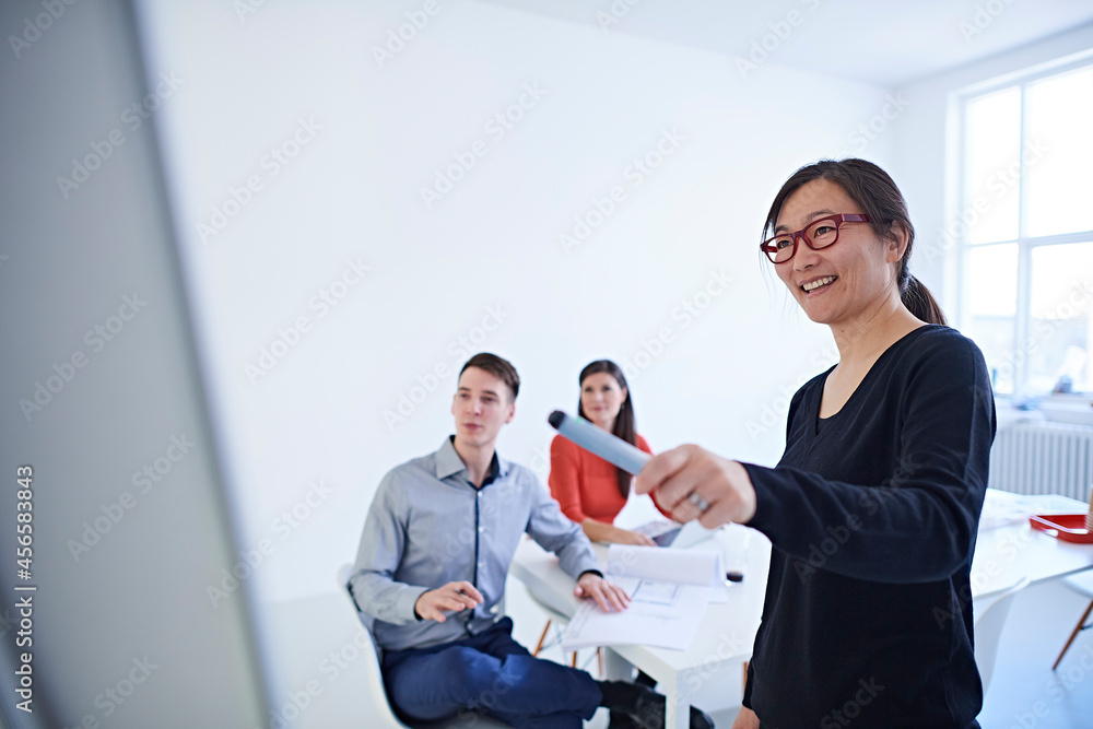 Colleagues in office watching presentation Colleagues in office watching presentation