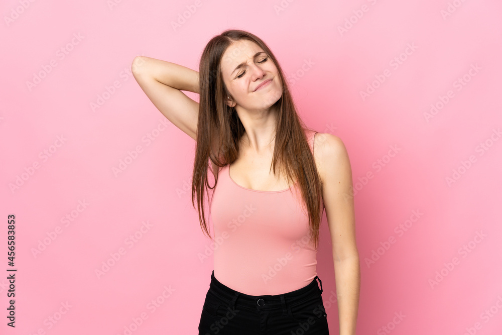 Young caucasian woman isolated on pink background with neckache
