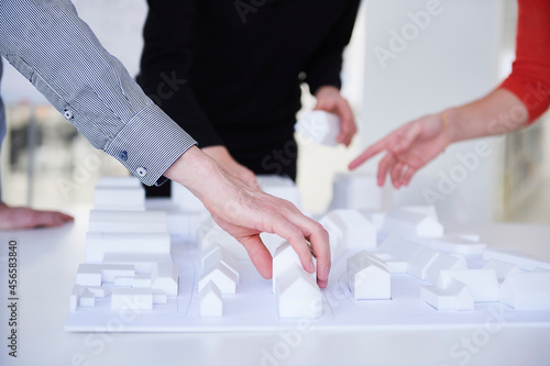 Colleagues in architect office with architectural model photo