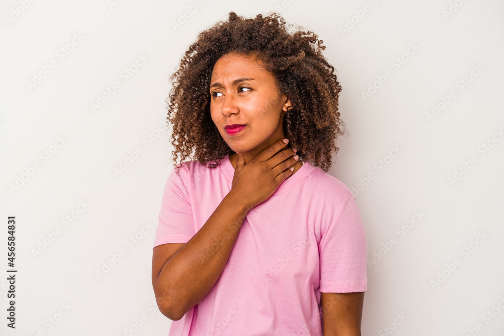 Young african american woman with curly hair isolated on white background touching back of head, thinking and making a choice. Young african american woman with curly hair isolated on white background touching back of head, thinking and making a choice.