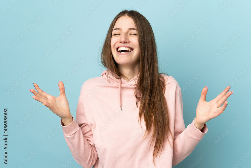 Young caucasian woman isolated on blue background smiling a lot Young caucasian woman isolated on blue background smiling a lot