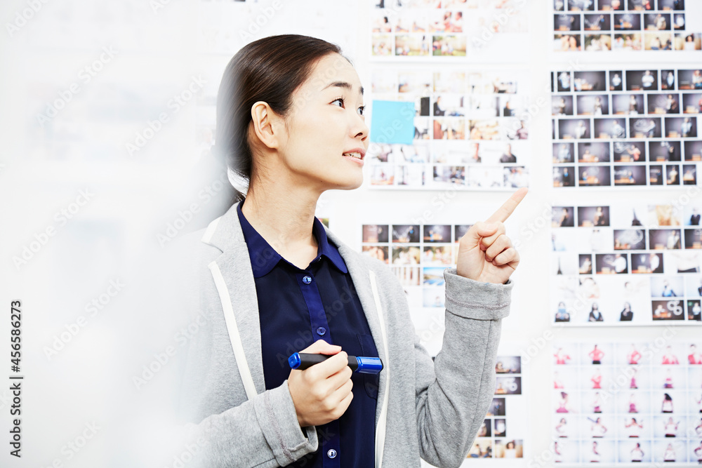 Young woman in creative studio, pointing Young woman in creative studio, pointing