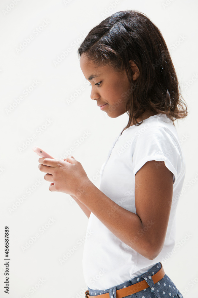 African American girl using cellphone, studio shot African American girl using cellphone, studio shot
