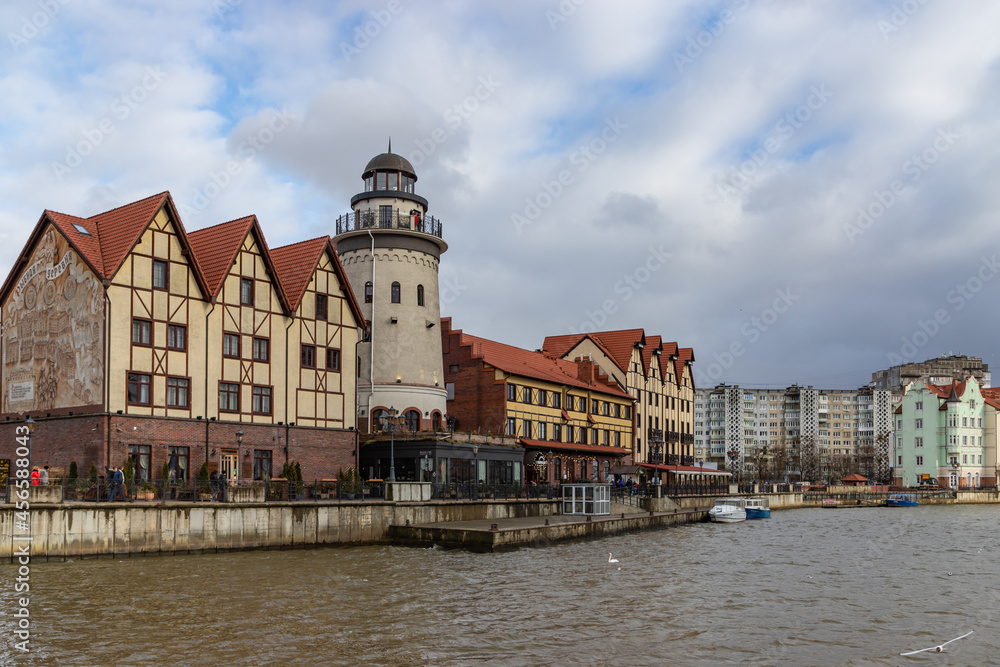 Naklejka premium View of Rybnaya Derevnya (Targ Rybny) on the bank of Pergolya (Pergola) river, in Kaliningrad, Russia
