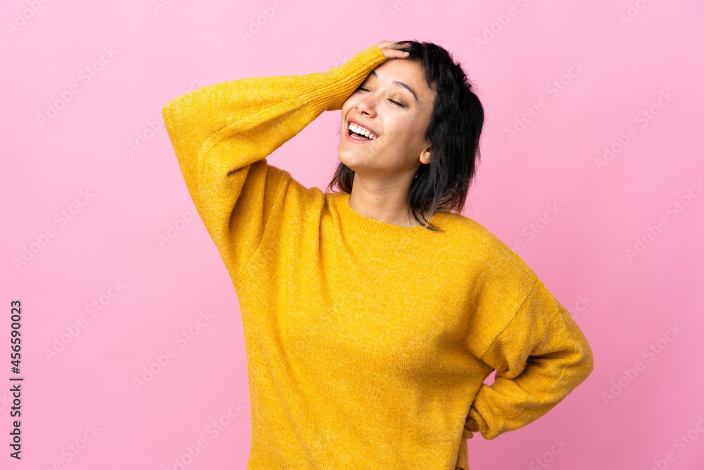 Young Uruguayan woman over isolated pink background smiling a lot Young Uruguayan woman over isolated pink background smiling a lot