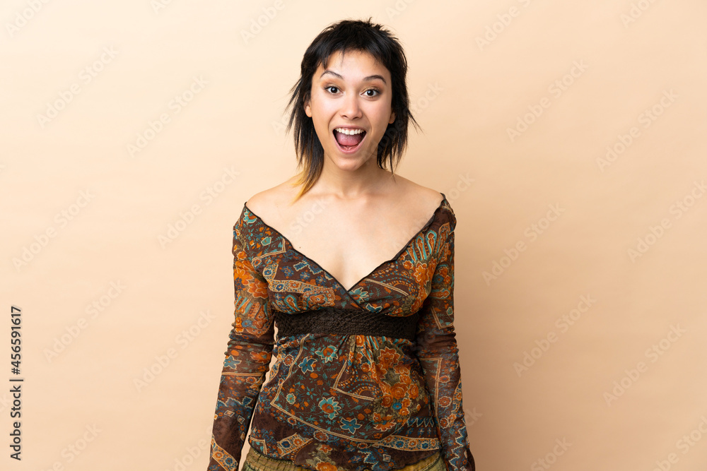 Indian woman isolated on beige background with surprise facial expression Indian woman isolated on beige background with surprise facial expression
