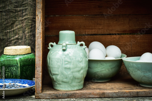 Canvas-taulu Celadon green Asian style ceramic bottle and bowls filled with white eggs inside