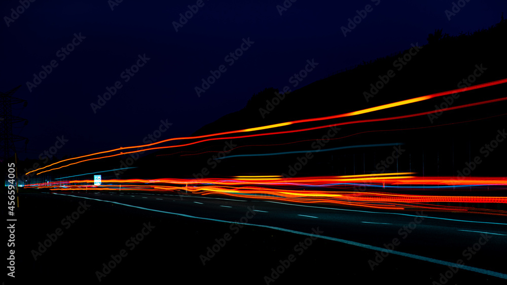 Night road lights. Lights of moving cars at night. long exposure red, blue, orange, multicolored