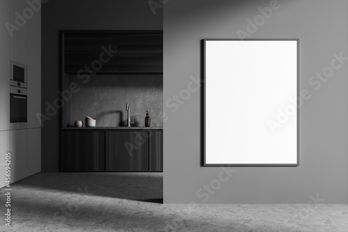 Front view on dark kitchen interior with empty white poster © ImageFlow