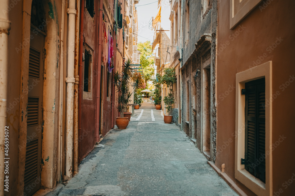 Beautiful cozy narrow street in old town of Italy or Greece. Historic european facades of buildings. Cityscape concept.
