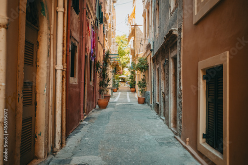 Fototapeta Naklejka Na Ścianę i Meble -  Beautiful cozy narrow street in old town of Italy or Greece. Historic european facades of buildings. Cityscape concept.