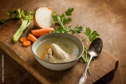 Fotografie chicken soup witn ingredients over cutting board