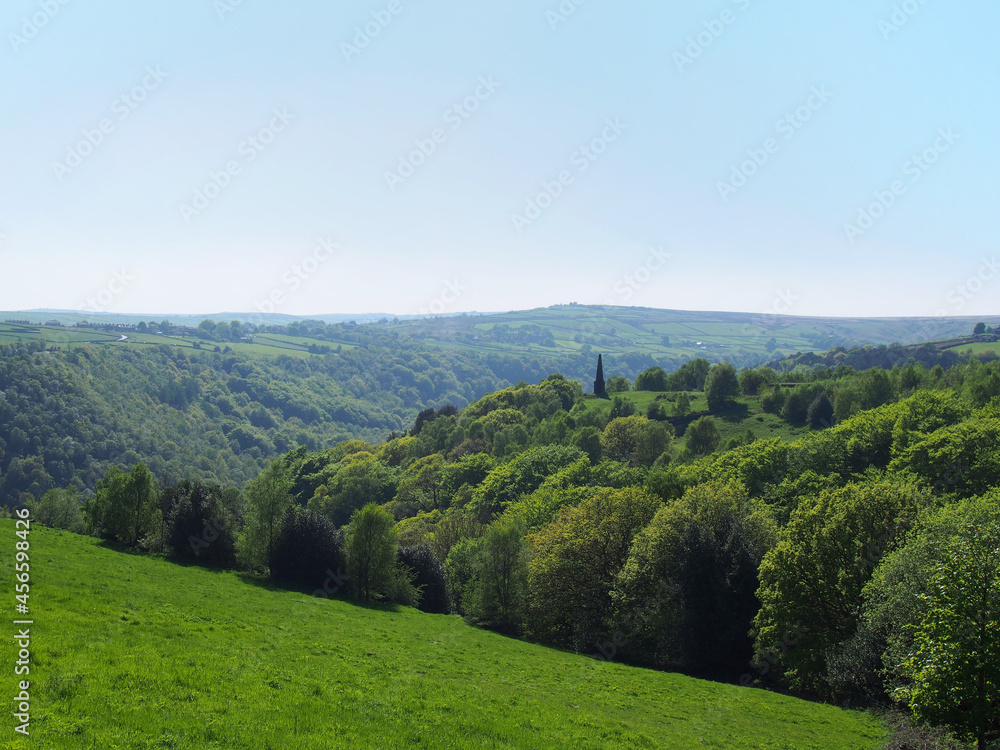 view of the valley and woodland looking over hardcastle crags with war memorial in calderdale west yorkshire